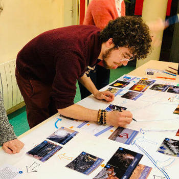 A participant adds a small drawing on the Collage